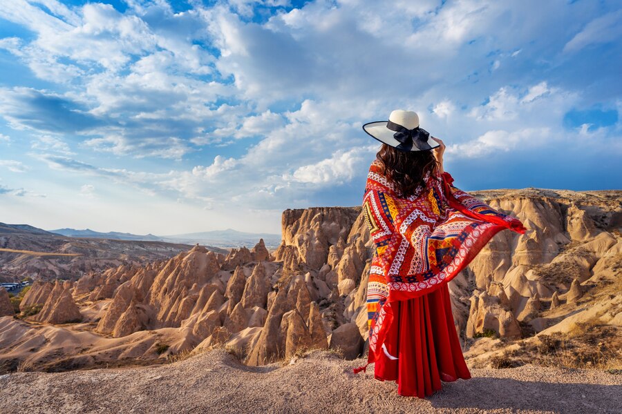 woman-standing-mountains-cappadocia-turkey_335224-577